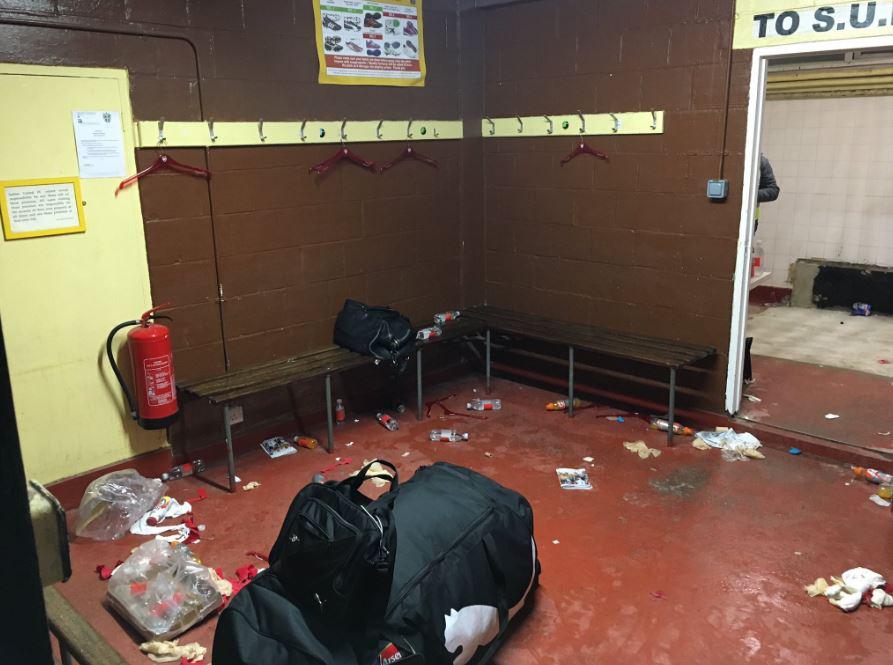  Bottles of drink and toilet roll litter the floor of the away changing room