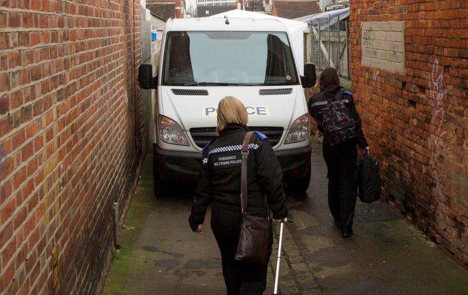  Forensic officers arrive at an alleyway that runs behind Halliwell's former home this morning