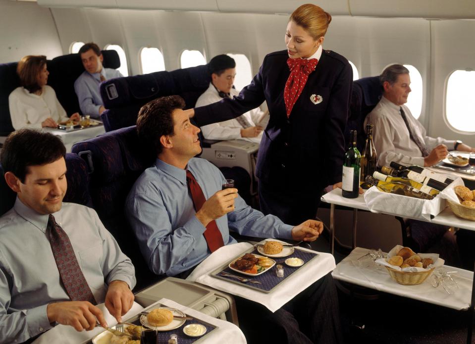  While flight attendants might be serving 10 people instead of 70 in the fancy cabins, their constant demands actually mean they work a lot harder  (file photo)