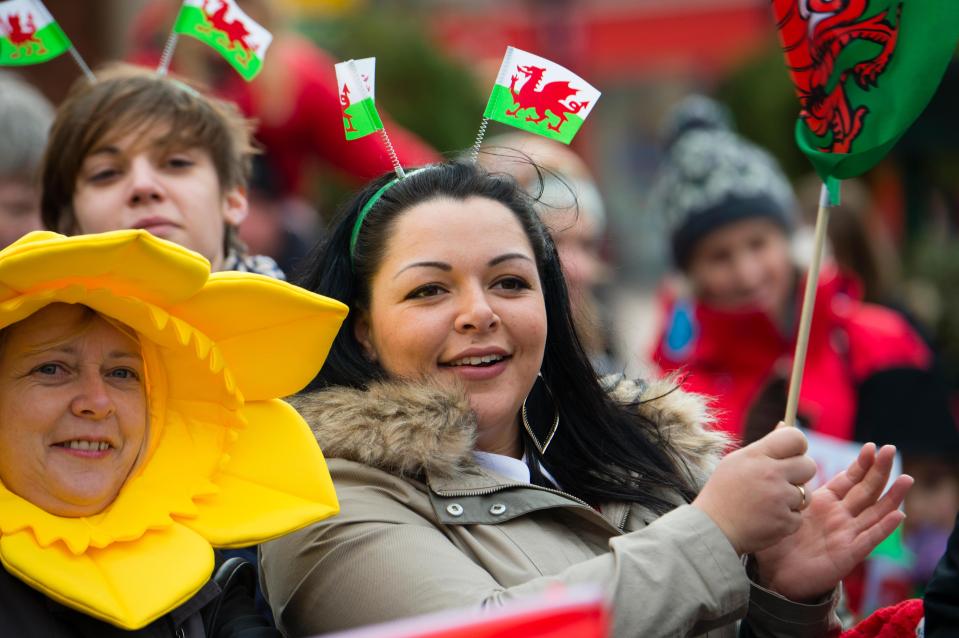  People dressed in patriotic Welsh costumes watch a Sat David's Day parade in Wrexham