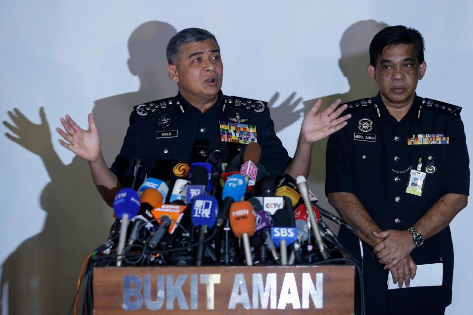  Malaysia's top cop Khalid Abu Bakar, left, today said police want to question the two men in connection with the killing