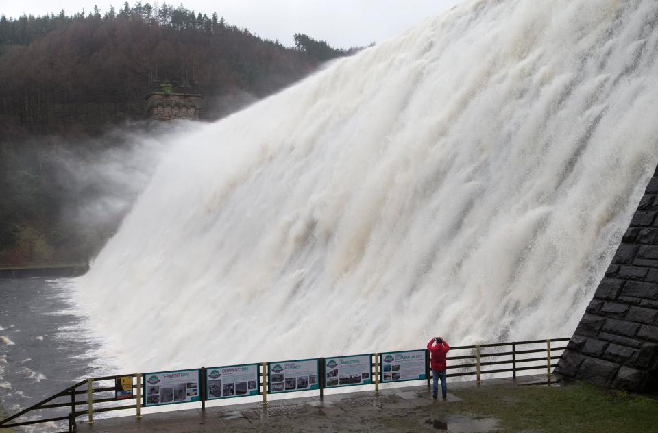  High winds and heavy rain send a vast torrent of water rushing over the Derwent Dam wall and into the air as Storm Doris batters the Derbyshire Peak District between Sheffield and Glossop