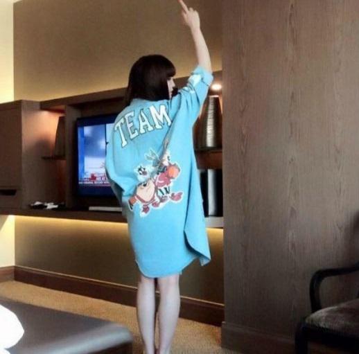  In this picture Huong poses in a hotel room in a bathrobe