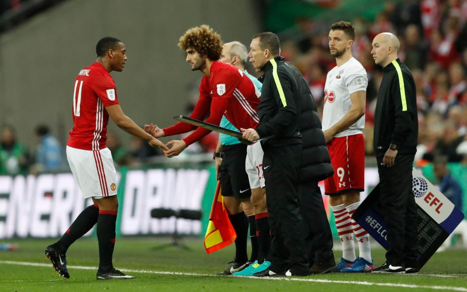  Marouane Fellaini came on to the field to replace Anthony Martial - and Rooney was told to sit back down