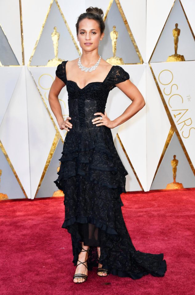  Last year's best supporting actress Alicia Vikander made a rare fashion misstep in her black lace dress