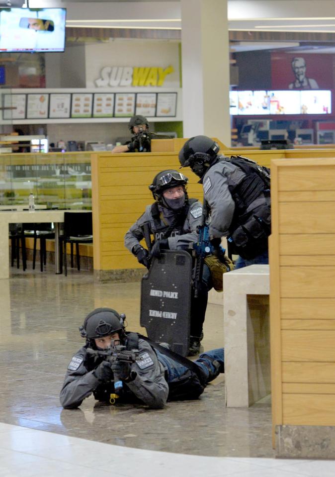  Cops appear to be devising a strategy outside this Subway as they prepare for the event of a terror attack