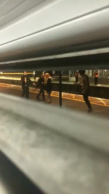  Another fight was seen developing on the platform outside the packed train