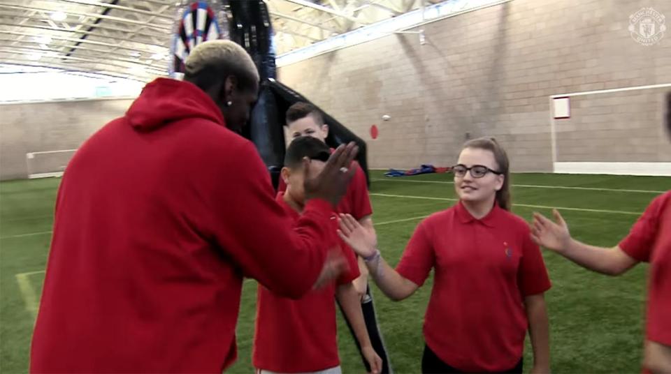  Pogba high-fives youngsters, bringing a smile to their faces