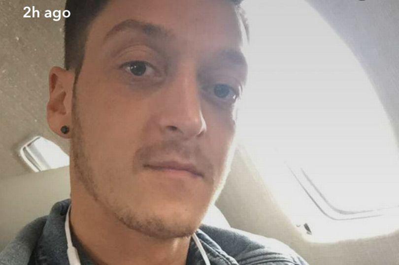  Mesut Ozil uploaded this picture of him on a plane on Monday afternoon