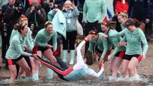 Coxswain Jasper Parish of Cambridge University Women’s Boat Club is thrown into the river after victory in The Gemini Boat Race