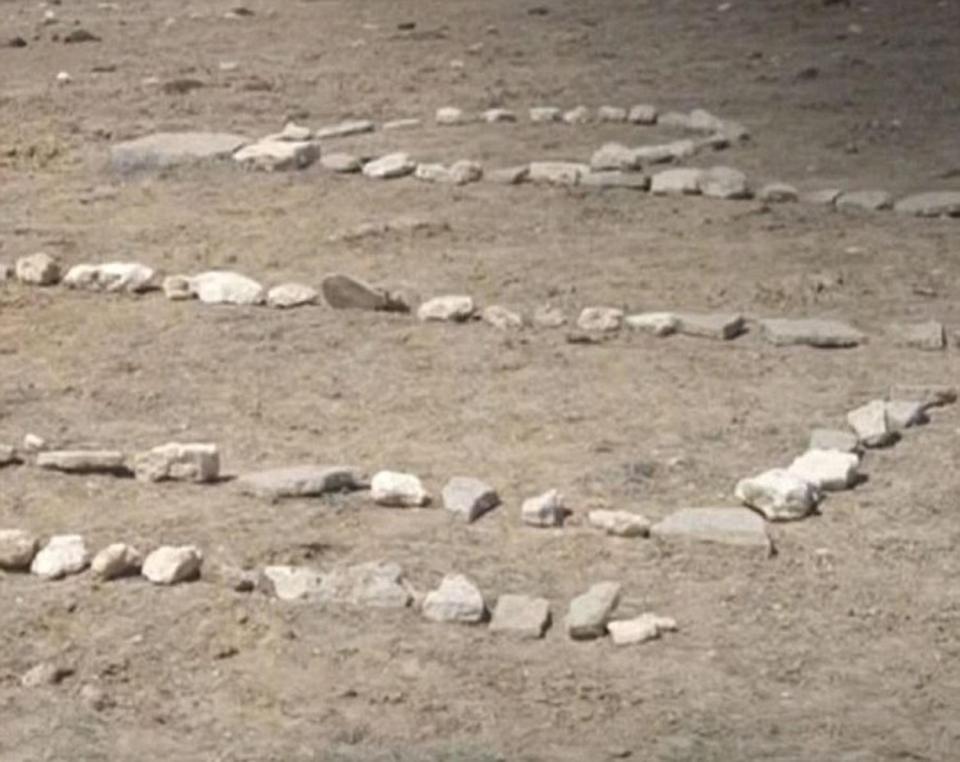  Amber wrote 'HELP' in rocks on the desert ground