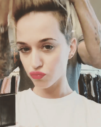 Katy's hairdresser flicks her hair up and down in the clip