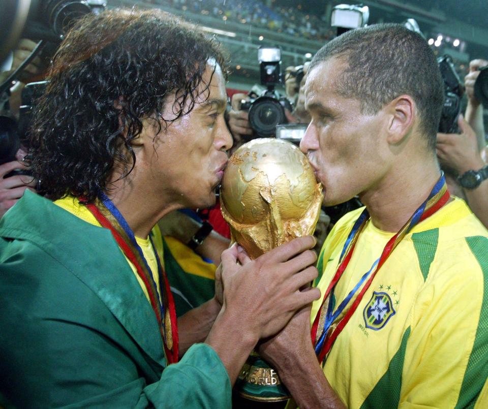  Ronaldinho celebrates winning the World Cup with Cafu in 2002