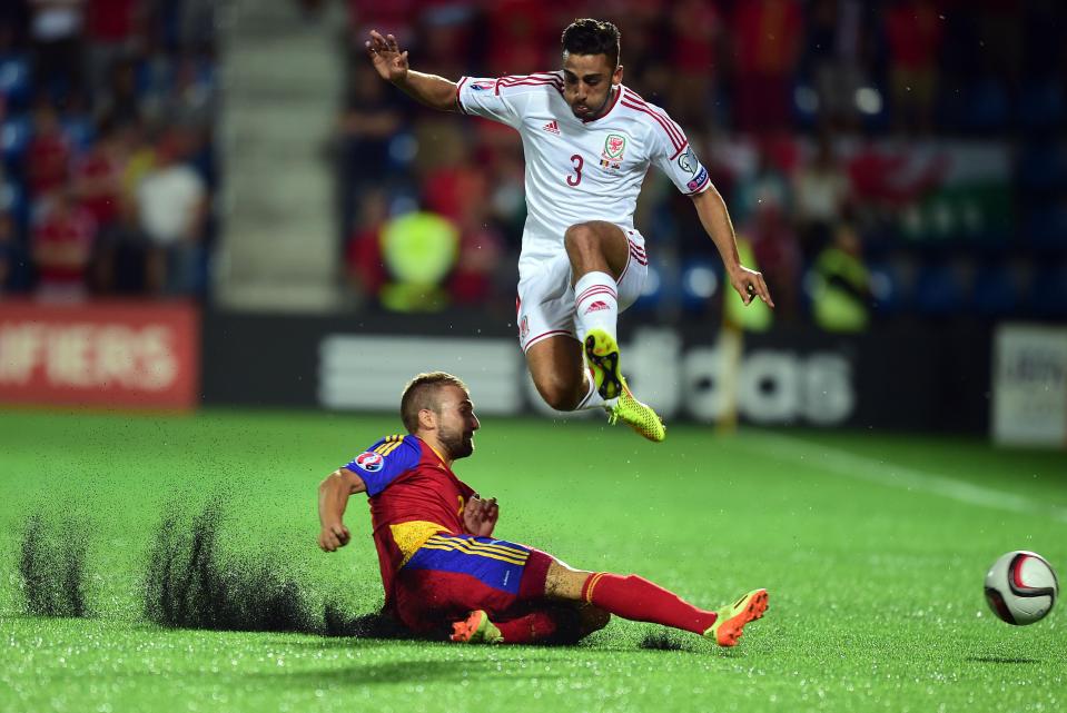  The turf cuts up under a challenge from Andorra's Jordi Rubio on Neil Taylor