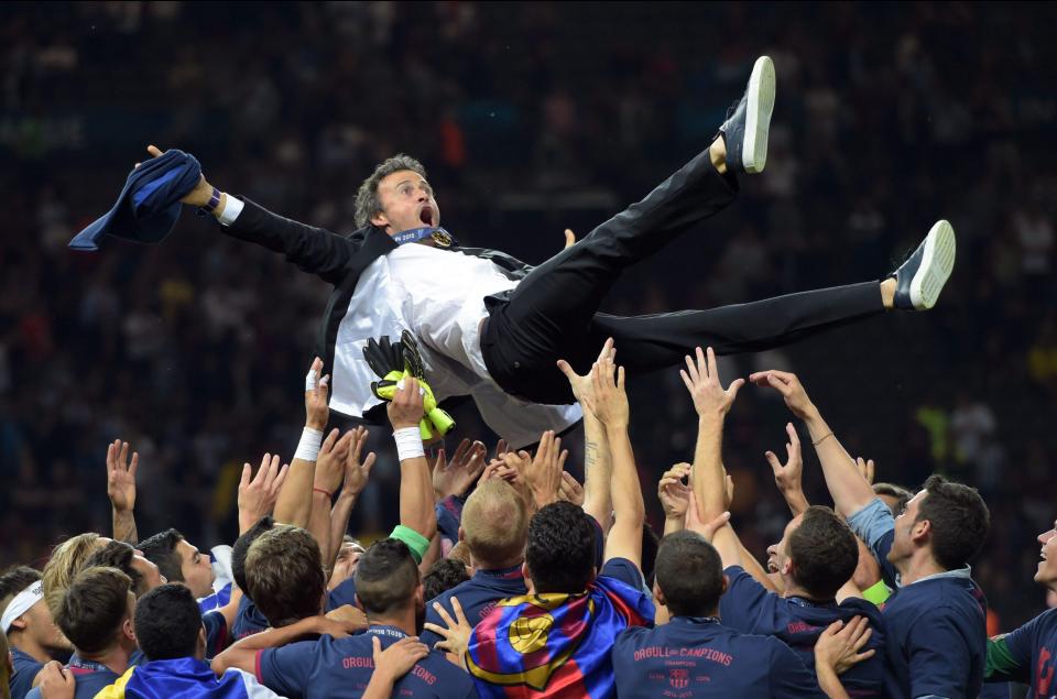  The Barca boss is hoisted aloft by his players after winning the Champions League in 2015 in his first season in charge