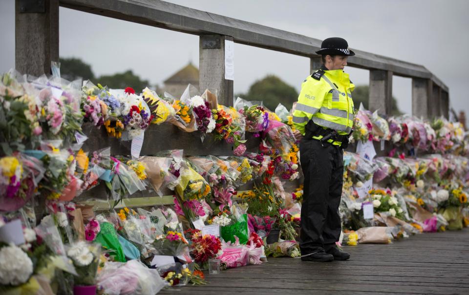  Flowers placed as tributes on a bridge near the crash site