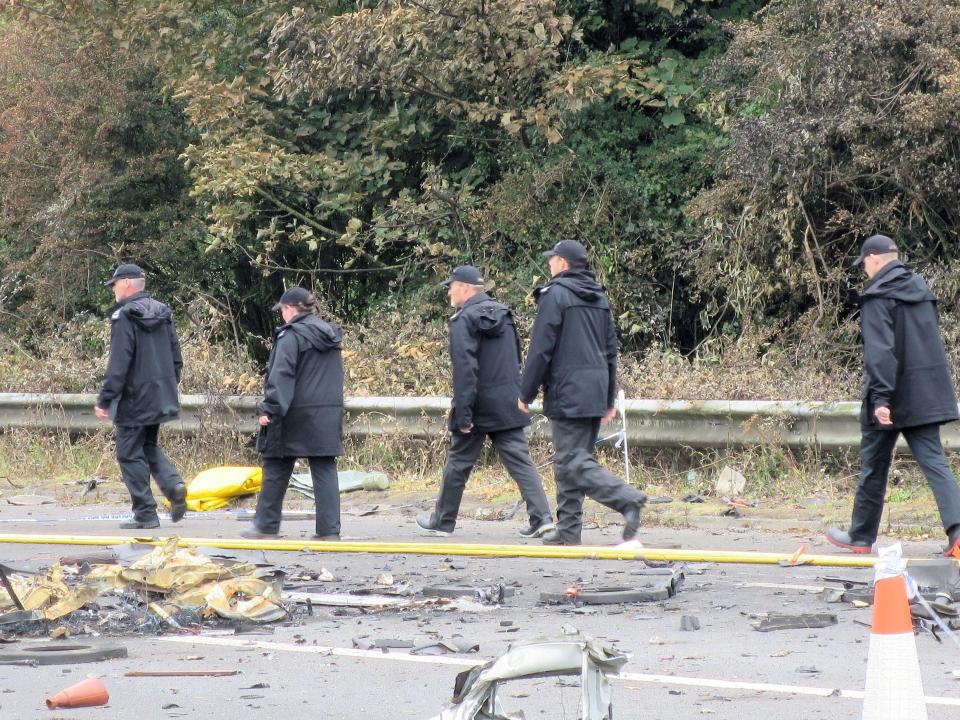  Investigators probe the scene of the smash on the A27, as they searched for victims