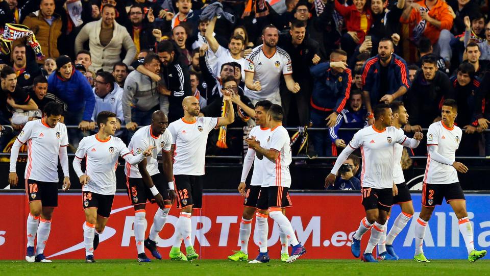  Valencia players celebrate after their victory over Real Madrid in La Liga clash