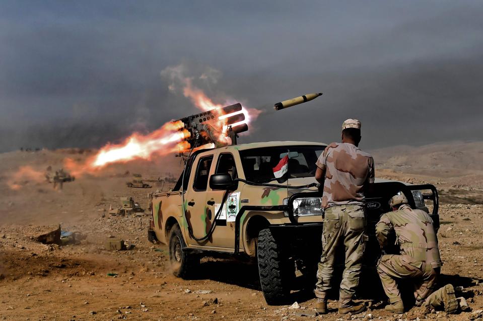  The Iraqi army's 9th Division fire rockets from a hill in Talul al-Atshana, on the south-western outskirts of Mosul