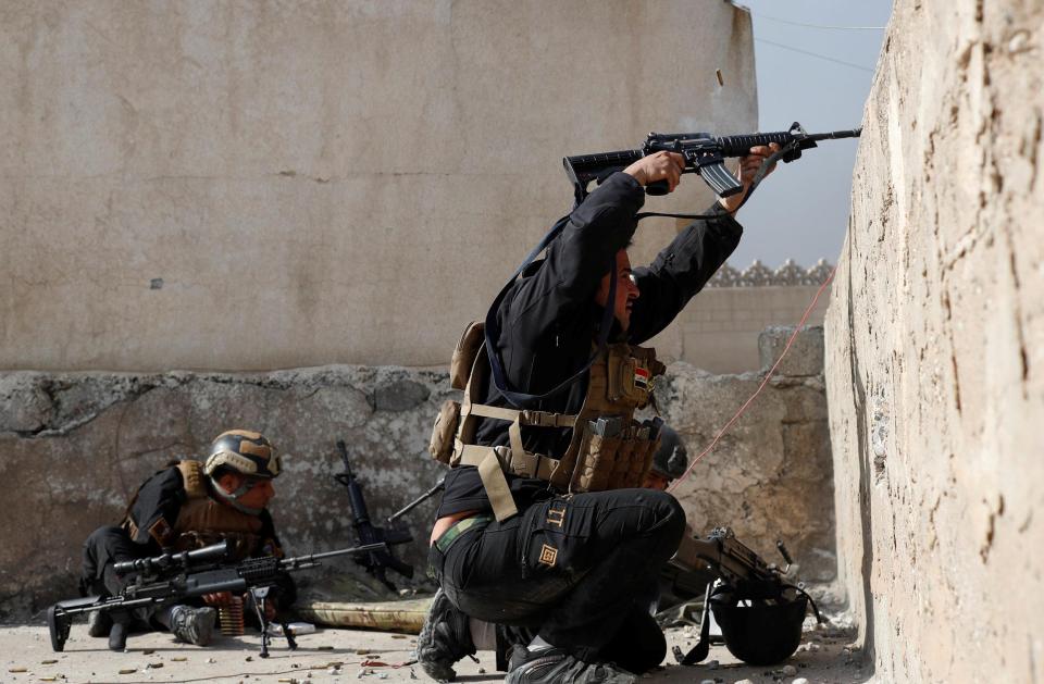  A special forces trooper fires his rifle in the direction of ISIS positions