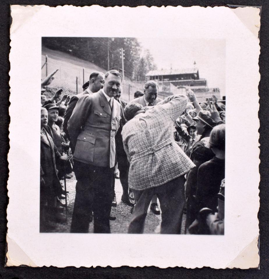  Hitler grins as he is greeting by fawning fans