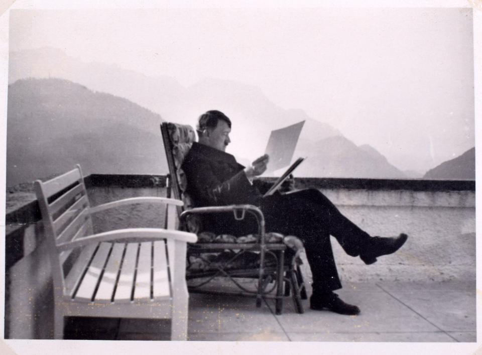  A candid photograph of Hitler studying papers at the Berghof is included in an album being put up for sale in Kent