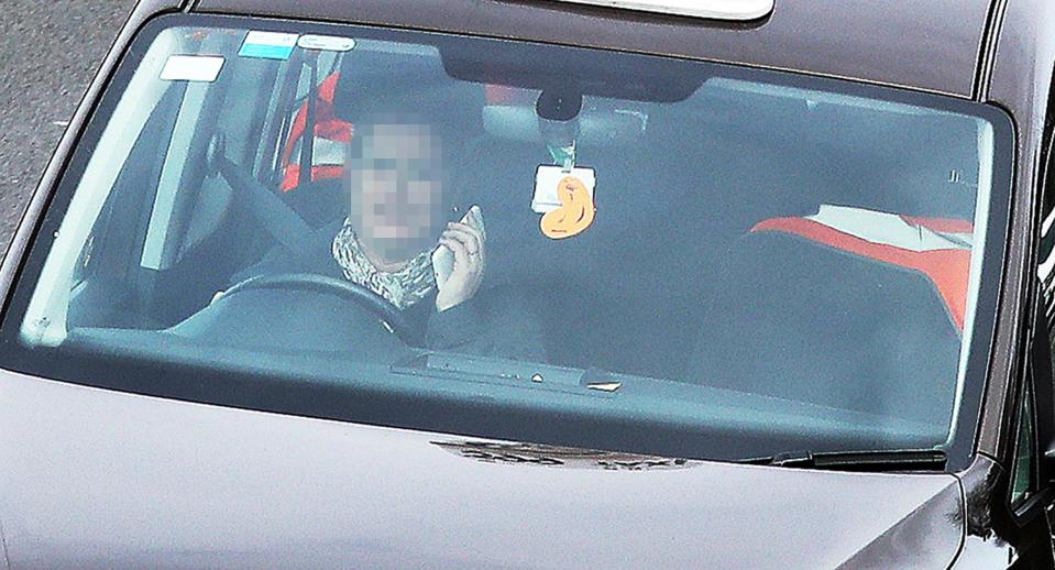  Police throughout the UK reported giving out fines and penalties to drivers on the day the tougher law came into force - a woman pictured here on her phone in Didcot