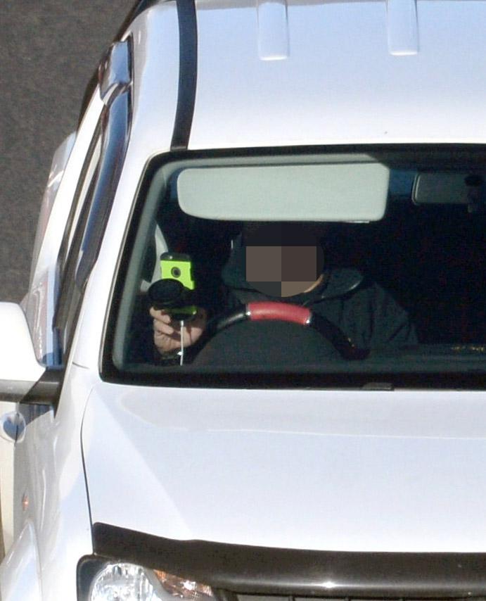  A driver pictured here touching his mobile phone as he moves through Edinburgh