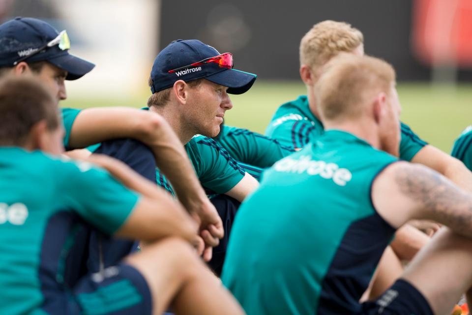  Morgan sits with the England players at a team meeting