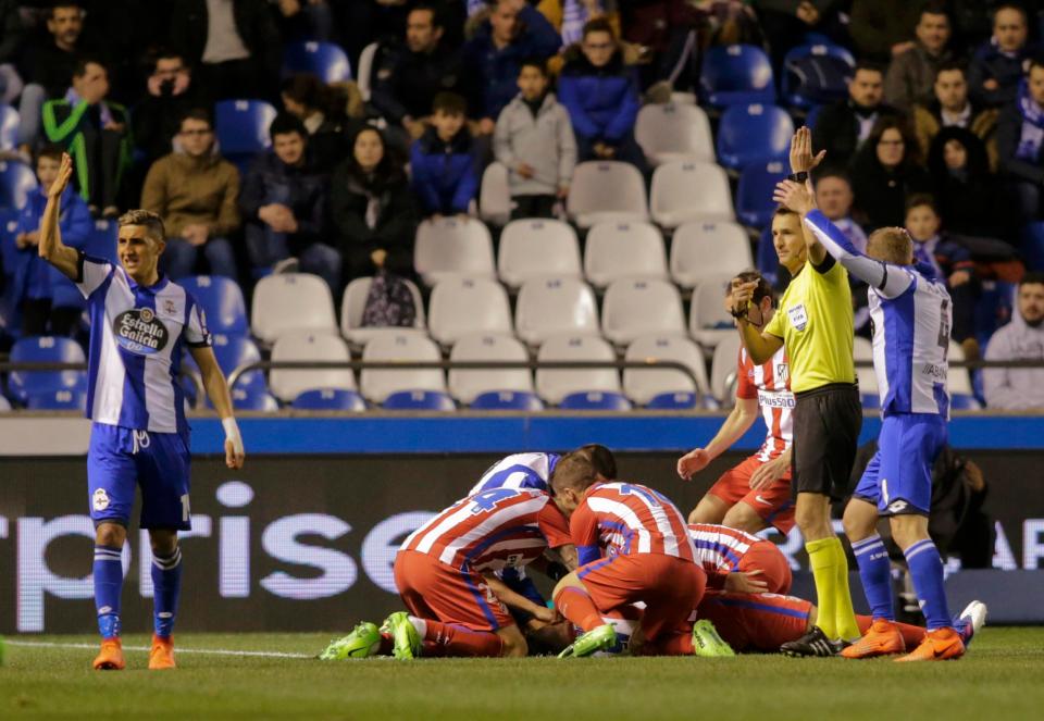  The referee frantically waved for medics after Torres was knocked unconscious while Atletico players rushed to his side