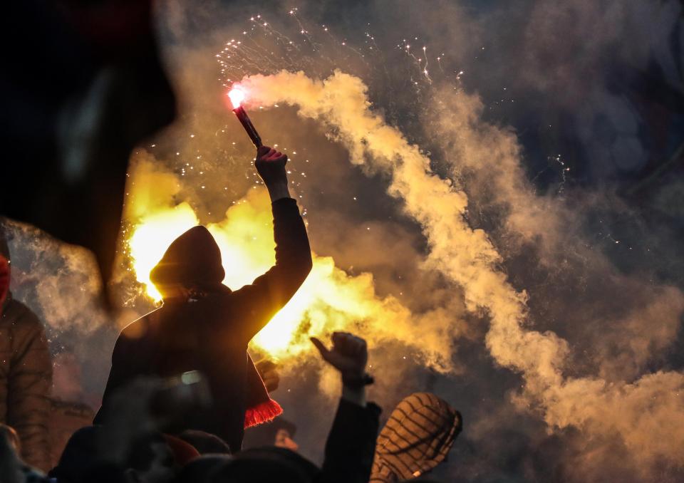  Falres and smoke bombs were hurled at opposing supporters