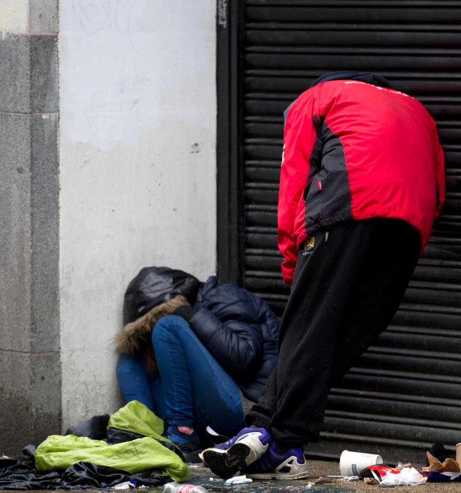  Two homeless people slump in doped-up stupours after taking new strain of Spice