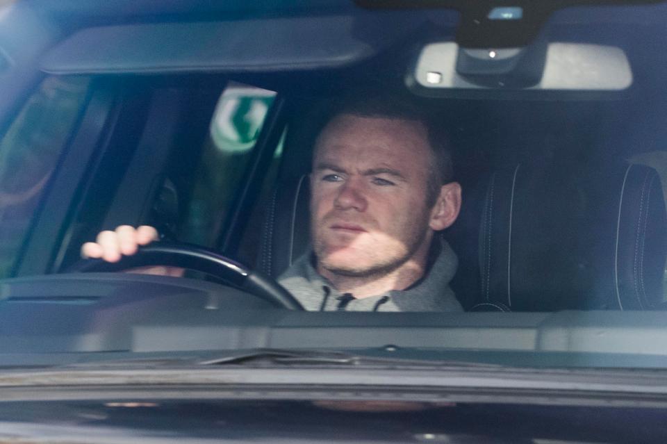  Rooney rolled into the training ground with sun blocked from his eyes