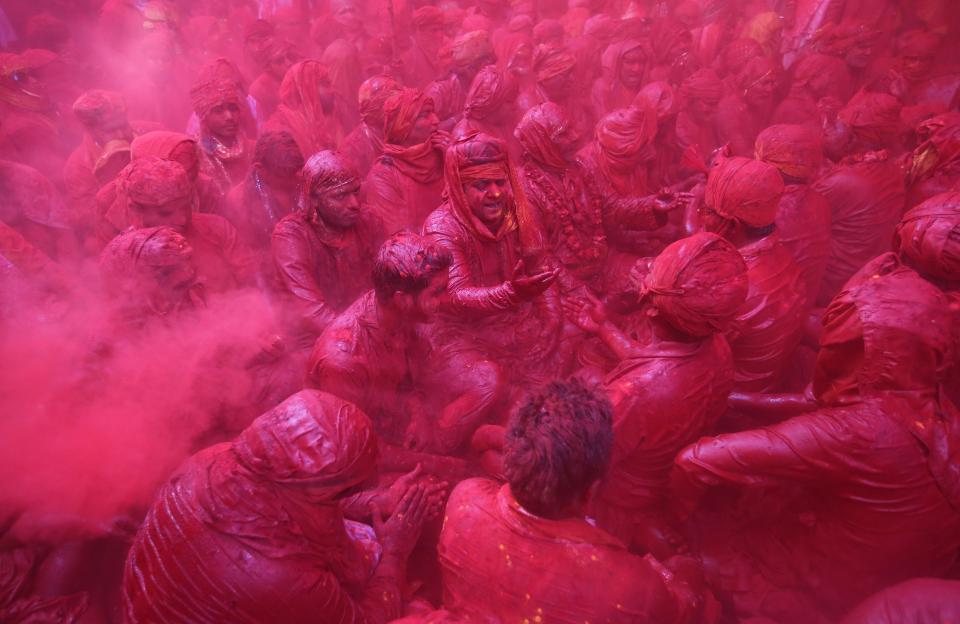  Hindu men from the village of Nandgaon celebrate covered with colored powder the Lathmar Holi festival