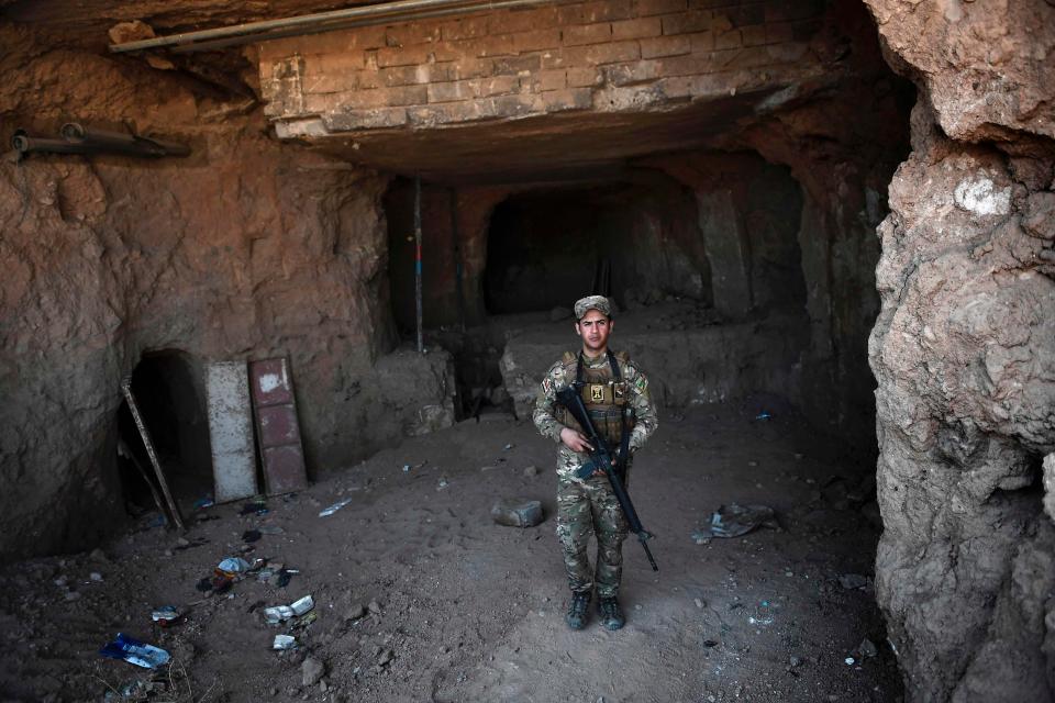  An Iraqi soldier stands guard at the entrance to the underground palace of the Assyrian King Esarhaddon