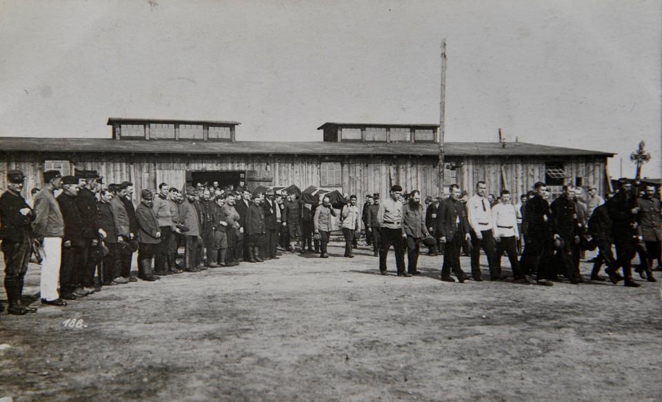  A pair of coffins are carried on the shoulders of me as mourners bow their heads in sympathy