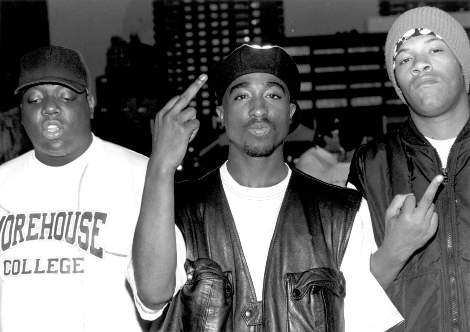 Notorious B.I.G. (left) and Tupas Shakur (centre) were members of rival hip hop groups. Pictured with rapper Redman (right)