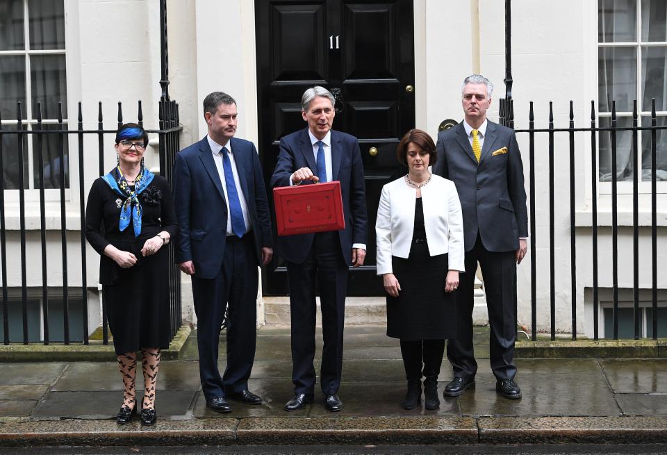  Mr Hammond proudly displayed the red box with his Treasury team outside No11