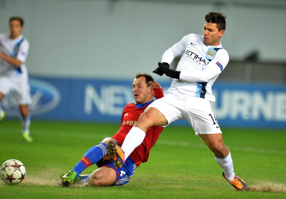  Sergei Ignashevich and Man City star Sergio Aguero in action amid the dust on the Moscow surface