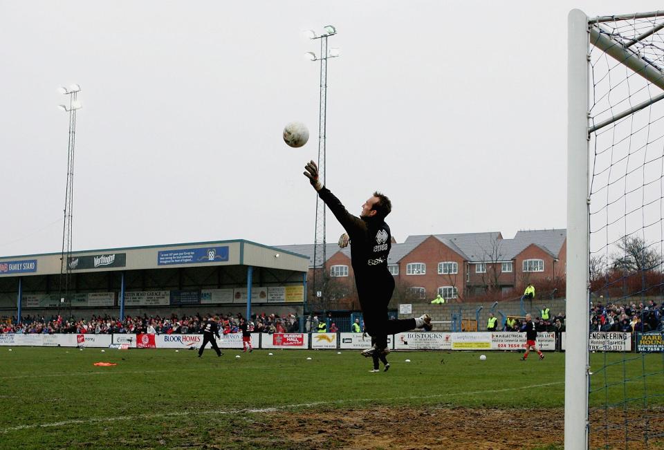  Mark Schwarzer warms up on a dodgy surface which only got worse