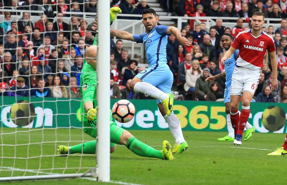  Sergio Aguero watches as his shot beats Brad Guzan to double the City lead