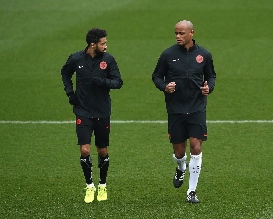  Kompany jogs with City team-mate Gael Clichy