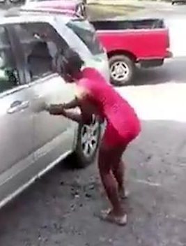  The woman also scratches the car using the hammer