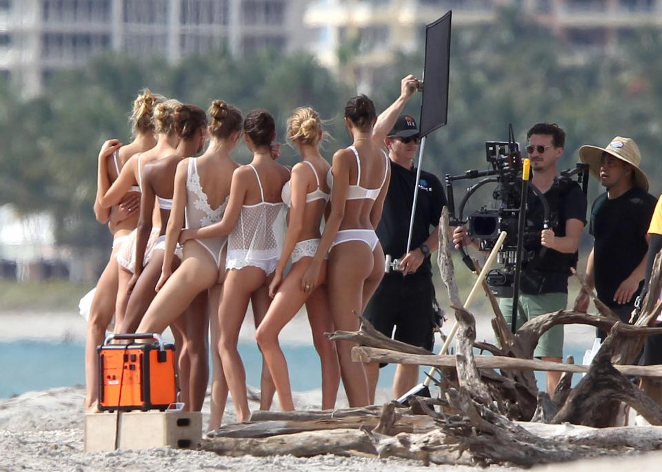  Beach dwellers were given an eyeful as the girls cosier up on the sand