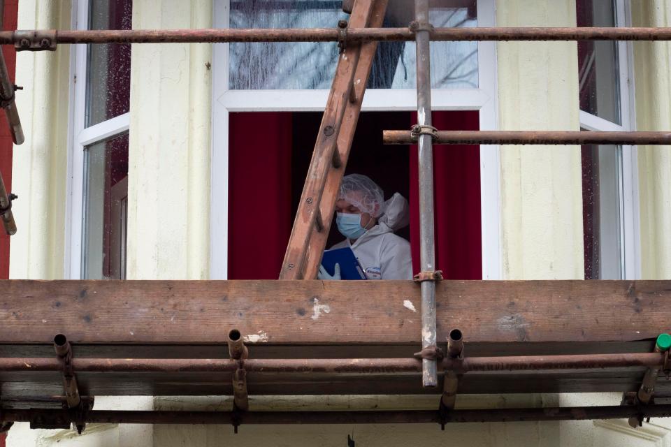  Forensics officers examine in the room where Williams butchered Cerys Yemm in November 2014