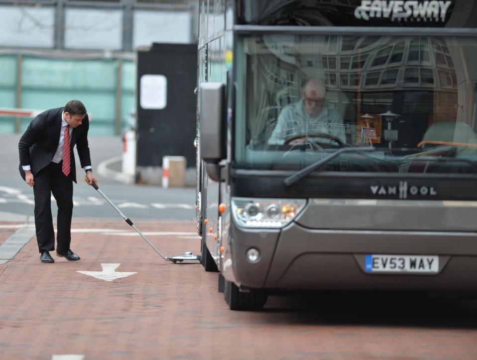  A security guard used a device to search underneath the team bus