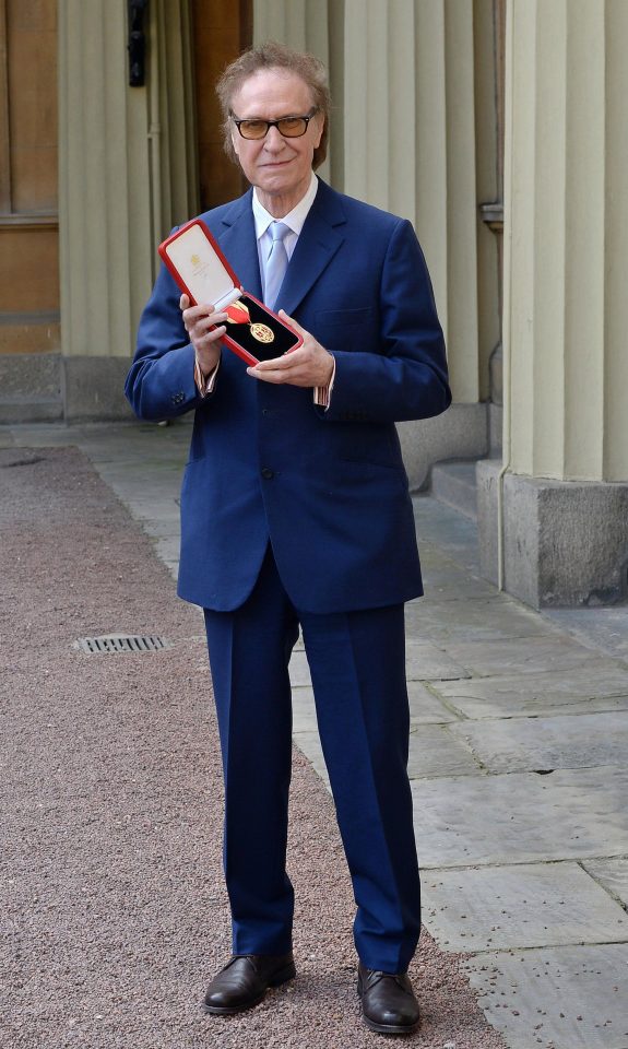  Sir Raymond scrubbed up smart in a navy blue suit to receive the honour