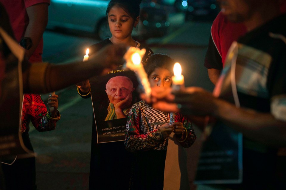 People hold candles as they gather for a night vigil to pray for Anti Apartheid struggle veteran and Rivonia trialist Ahmed Kathrada currently ill in hospital last week