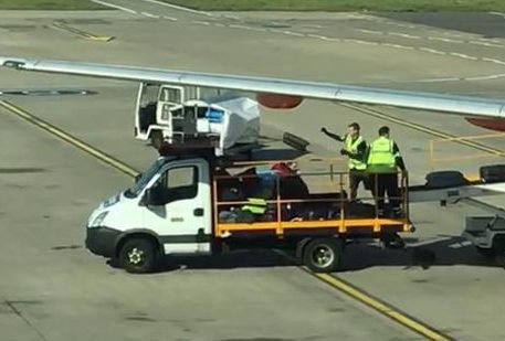  Shocked travellers watched out the window of the Luton plane, watching the baggage handlers