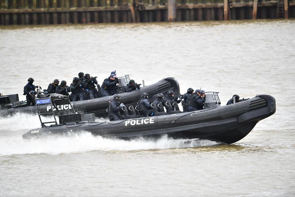  Officers dressed all in black raced along the river towards the cruise boat